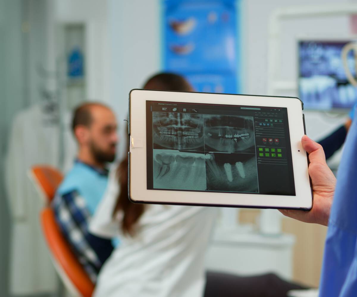 In a dental practice showing dental X-ray images on a tablet screen