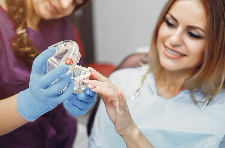 Dentist explains the denture process to the patient