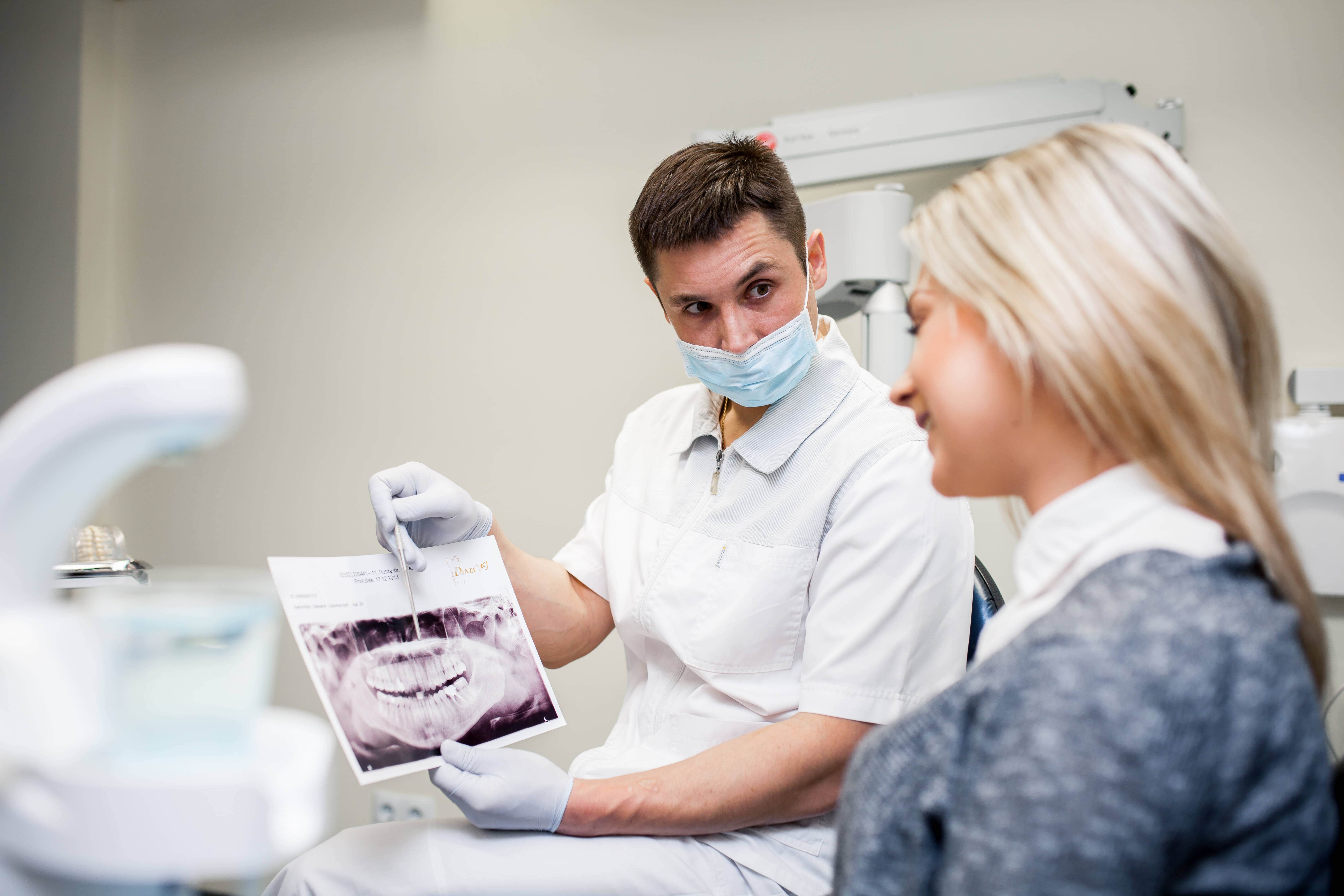 A dentist reviewing a patient's dental imaging report.