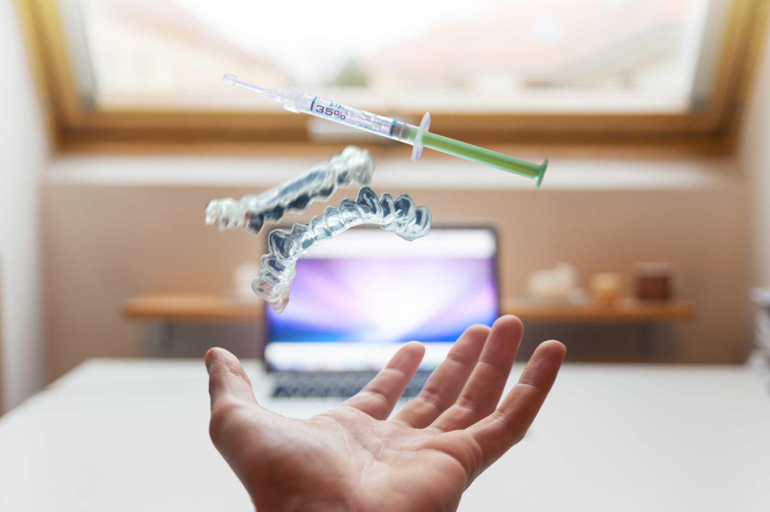 a hand removes dental plaque and implants