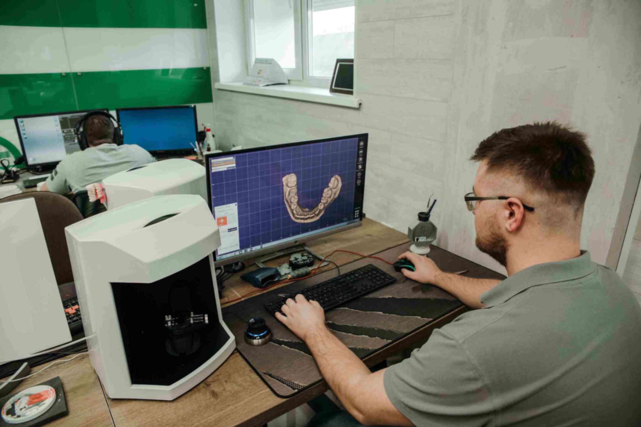 dentist working on a computer planning treatment for a patient