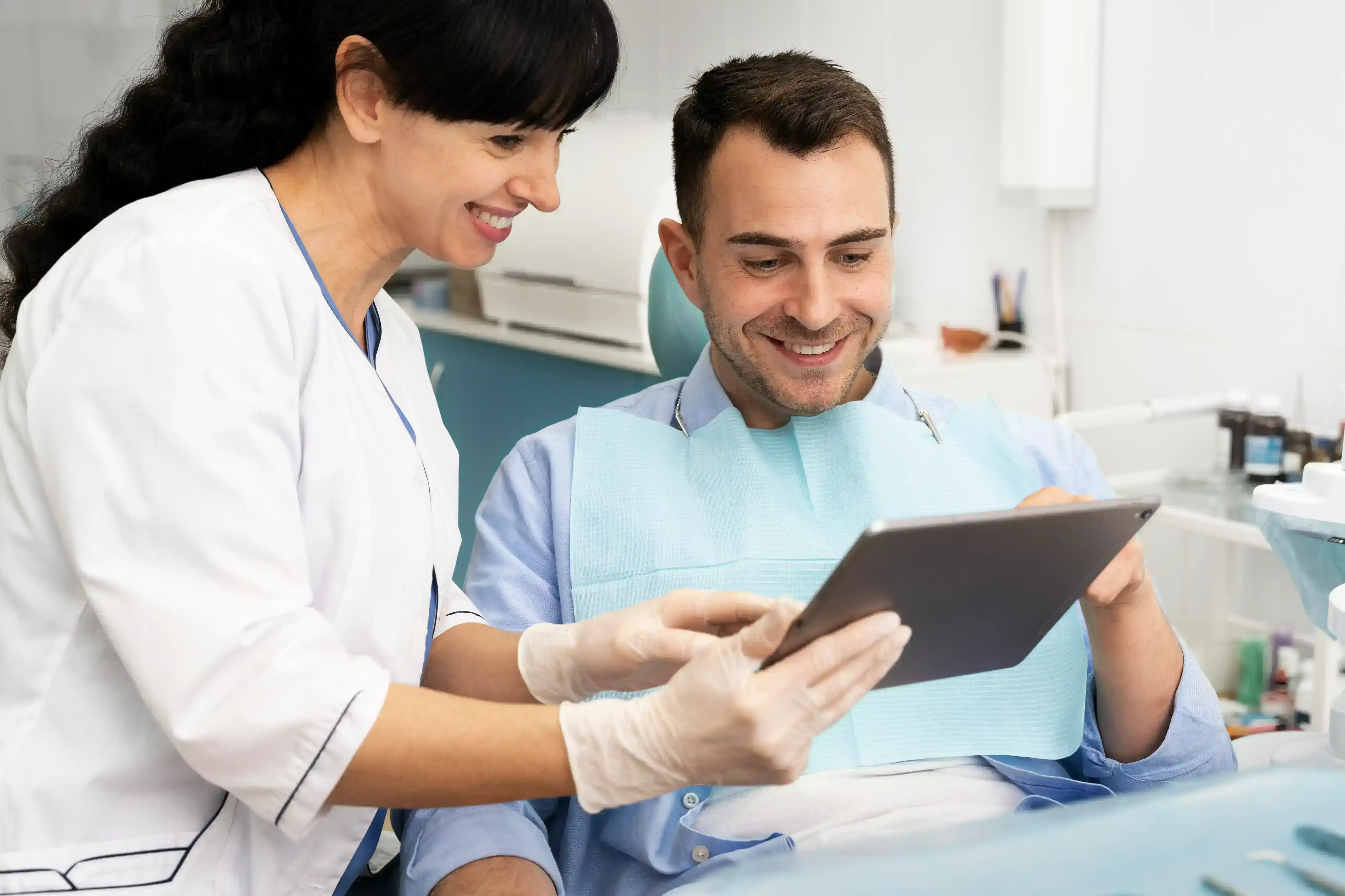 A dentist carefully examining a patient, offering a second opinion on their dental health.