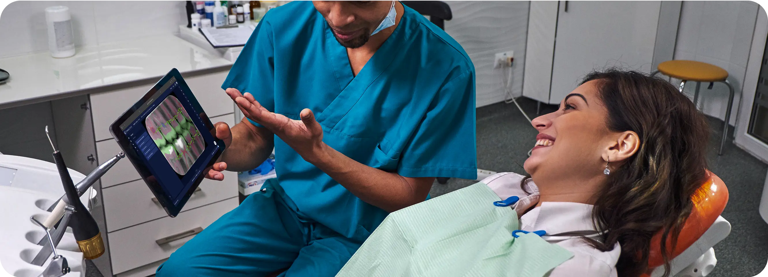 Dentist shows AI-annotated dental X-ray on a tablet